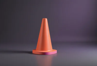 A bright traffic cone standing alone on a smooth floor