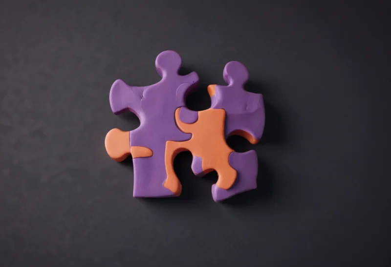 A single jigsaw puzzle piece standing on its edge.