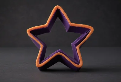 A matte-clay star-shaped cookie cutter standing upright in a flat sheet of dough
