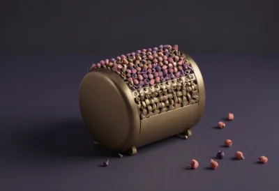 A brass music box cylinder studded with tiny raised pins