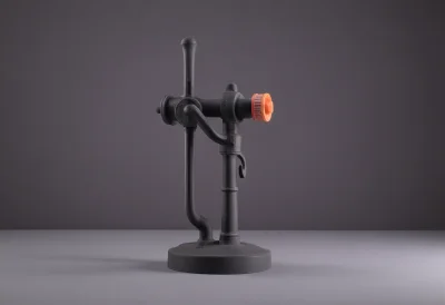 A cast-iron railroad switch stand with a round throw lever.